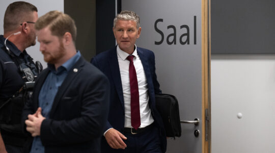 German politician enters a courtroom